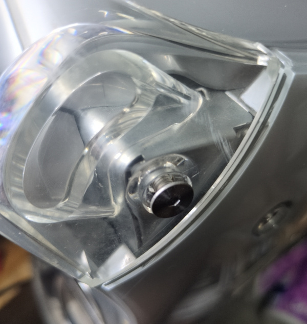 Photo of the corner leg of the computer with the allen bolt partially screwed out.