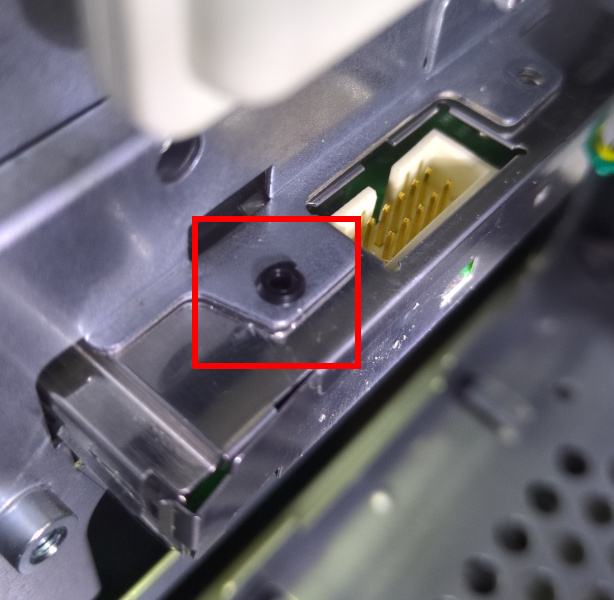 Plastic rivet socket on the rear of the power board box inside of the PC.