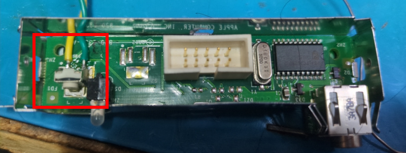 Two wires soldered to the connections on the rear of the physical power button on the power board.