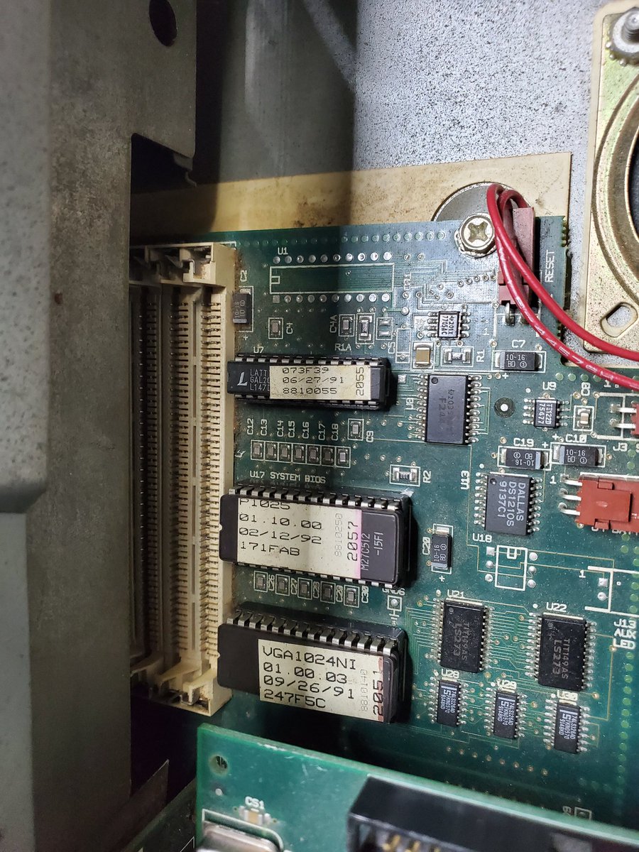 The left half of the motherboard of the Tandy 4850 EP, in front of the risers. ROM chips and GALs are visible.