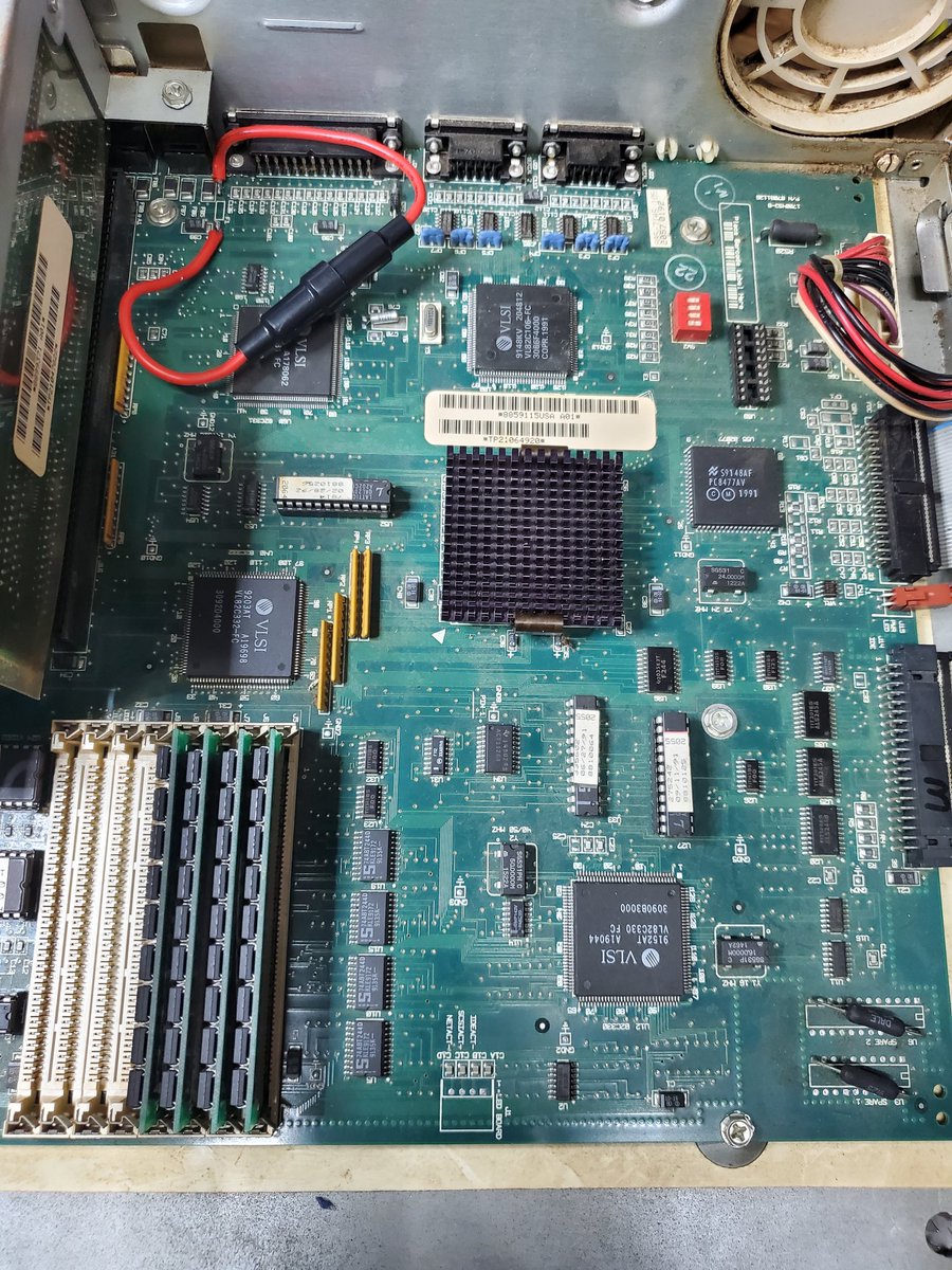 The right half of the motherboard of the Tandy 4850 EP. Many chips are visible. The 486 is under a small, black heatsink. The keyboard fuse has been replaced with an awkward large fuse holder.