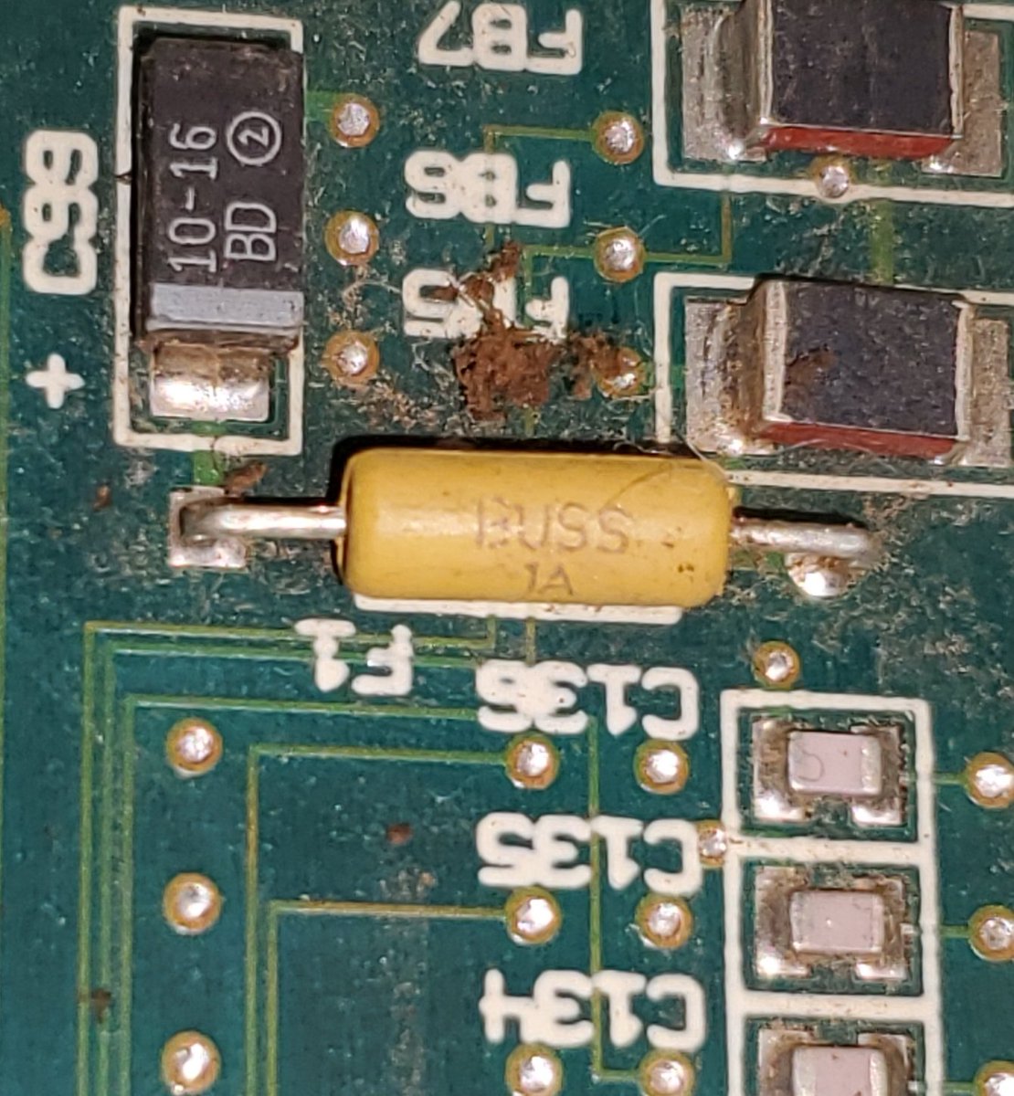 Closeup of the original Tandy 4850 EP keyboard fuse. A tiny, inconspicuous yellow-green cylinder.